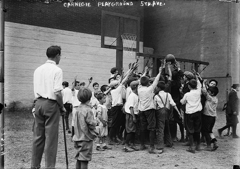 Boys reaching for a basketball in a playground, New York, 1911